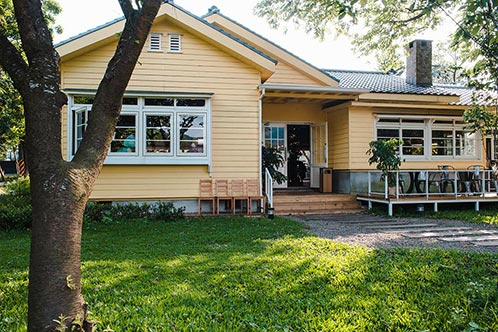 Charming Yellow House with Wooden Windows